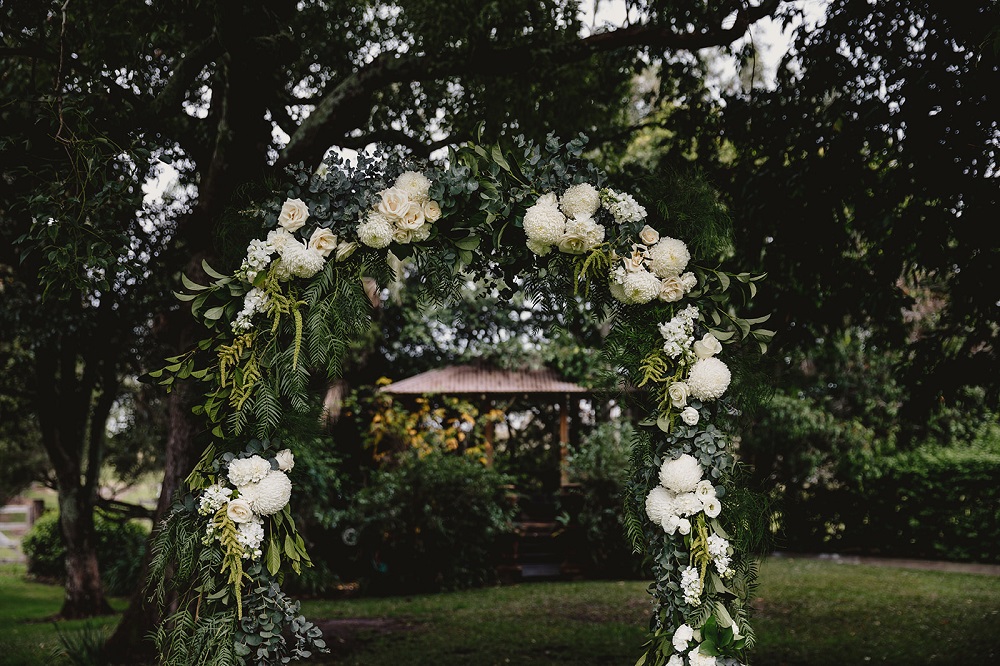 white flowers wedding arch