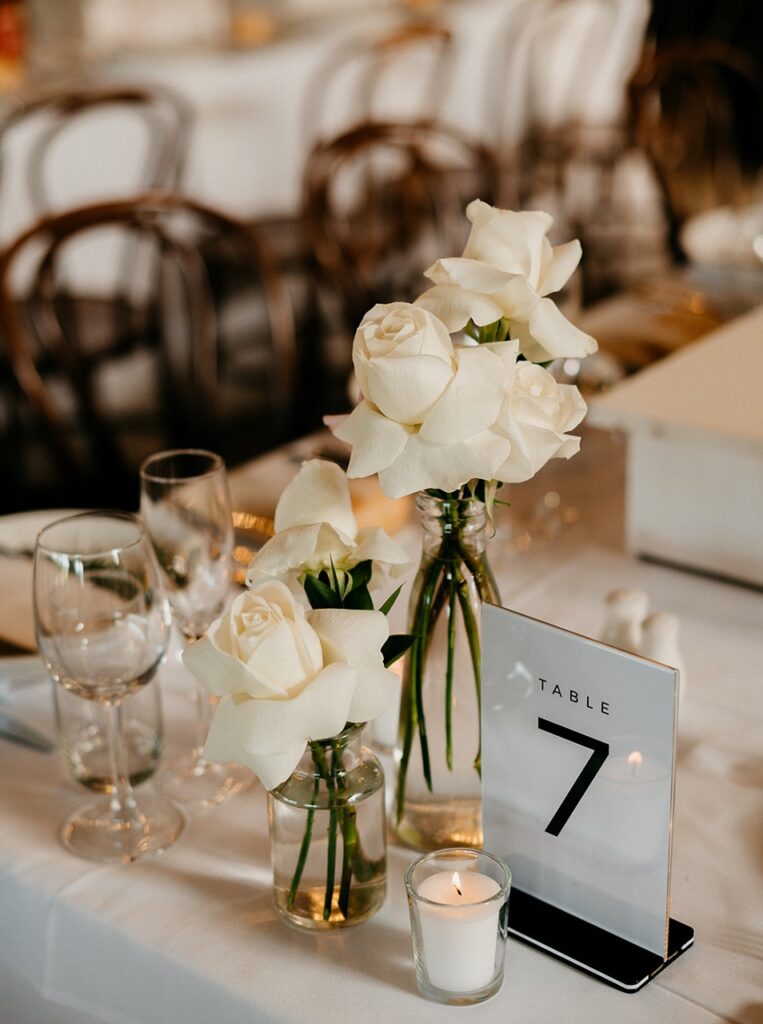 wedding reception white rose arrangements and table numbers