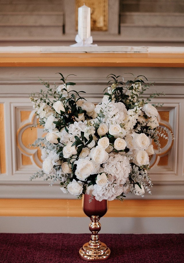 Wedding ceremony white flowers in gold urn arrangement